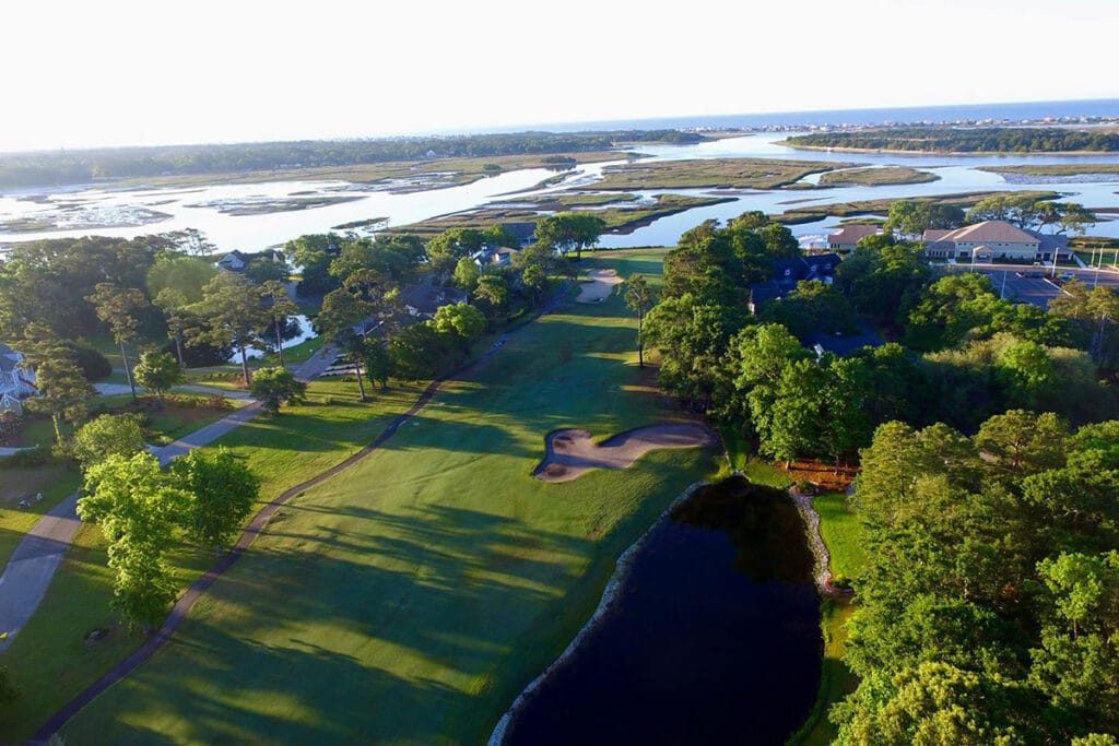 Aerial view of Lockwood Folly golf course surrounded by lush greenery and coastal waterways.