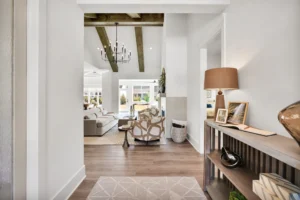 Modern living room with wood beams, natural light, neutral tones, and cozy contemporary décor.