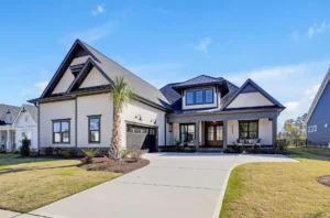 Modern farmhouse exterior with white siding, dark trim, gabled roof, and inviting covered porch.