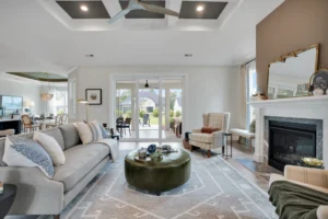 Elegant open-concept living room with neutral décor, fireplace, and natural light from French doors.