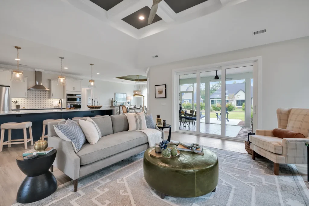 Let Us Reintroduce Ourselves 18 Bright modern open-concept living room and kitchen with natural light and neutral contemporary décor.