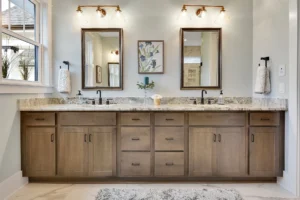 Bright modern bathroom with light wood double vanity, black faucets, and neutral elegant design.