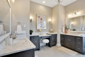 Elegant modern bathroom with double vanity, dark wood cabinets, and warm neutral lighting.