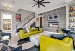 Modern living room with yellow-green sofas, concrete fireplace, and stylish contemporary interior design.