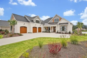Modern suburban home with brick and stone exterior, large windows, and landscaped front yard.