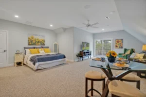 Spacious open-concept bedroom with sunflower decor, blue bedding, and bright natural light.