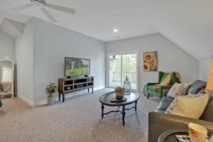 Cozy gray living room with sloped ceilings, natural light, and modern neutral decor.