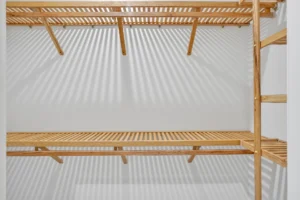 Minimalist wooden slat closet shelving with natural light, clean lines, and modern storage design.