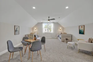 Bright modern loft with neutral decor, cozy seating, and natural light for relaxing or entertaining.