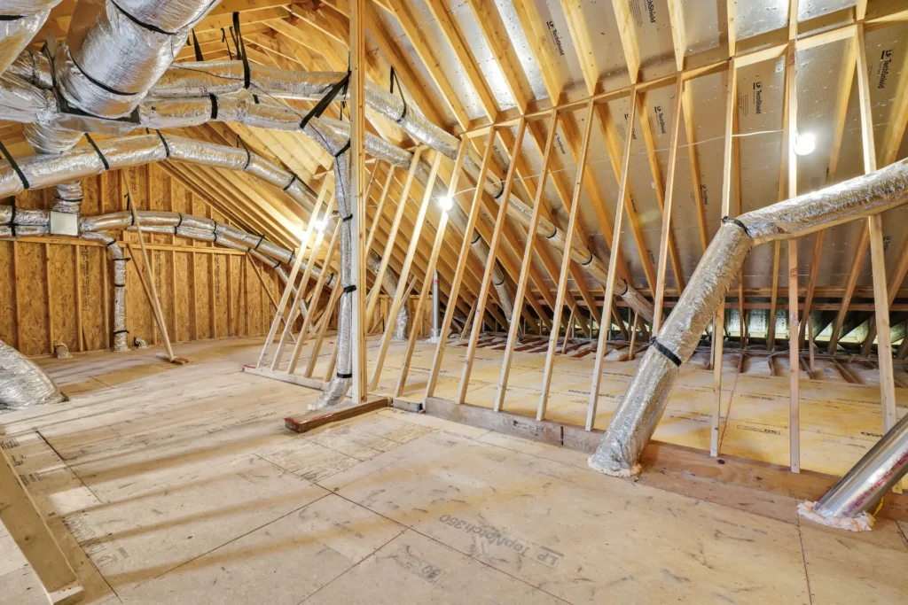Let Us Reintroduce Ourselves 6 Unfinished attic with exposed wood framing, insulated HVAC ducts, and potential for storage or living space.