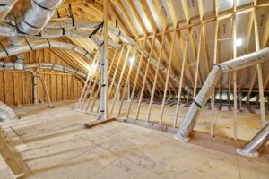 Unfinished attic with exposed wood framing, insulated HVAC ducts, and potential for storage or living space.