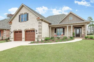 Modern white brick farmhouse with stone accents, two-car garage, and inviting front porch.