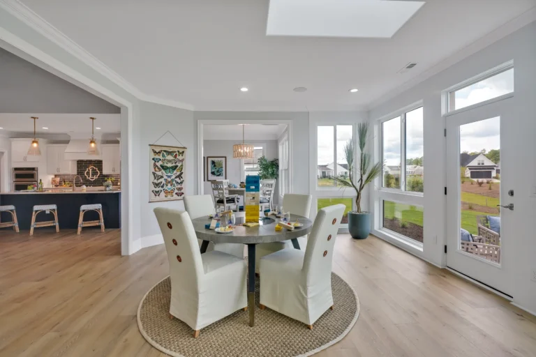 Bright modern open-concept dining and kitchen with natural light and contemporary decor.