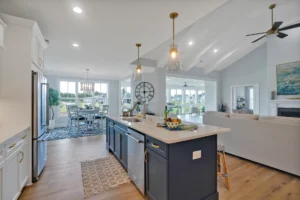 Modern open-concept kitchen and living room with navy island and coastal farmhouse design.