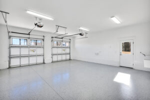 Bright modern two-car garage with glossy epoxy floor and white walls for parking or storage.
