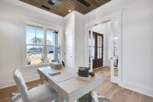Bright modern home office with natural light, wood accents, and serene outdoor views.